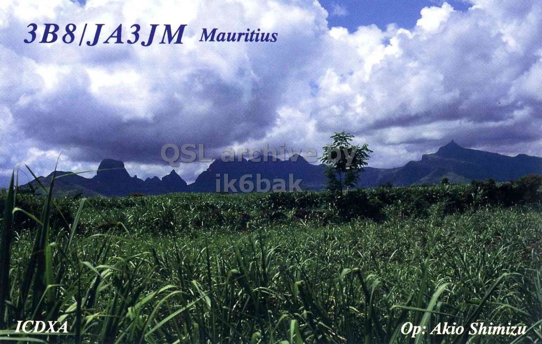 Front QSL card, of 3B8/JA3JM to IK2GRA, December 21, 1995, CW mode. The QSL image contains the following objects: Field, Vegetation, Nature, Outdoors, Pasture. And contains this text: 3B8|JA3JM Mauritius ik6bak ICDXA Op: Akio Shimizu Mauritius QSL ik6bak ICDXA Akio Shimizu.