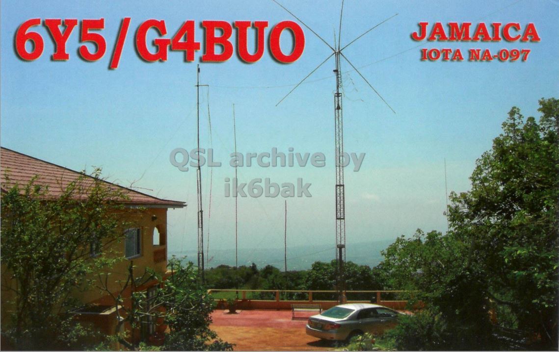 Front QSL card, of 6Y5/G4BUO to IK2GRA, April 6, 2012, CW mode. The QSL image contains the following objects: Car, Building, Electrical Device. And contains this text: JAMAICA IOTA NA-097 QSL archive by ik6bak JAMAICA IOTA NA-097 QSL archive by ik6bak.