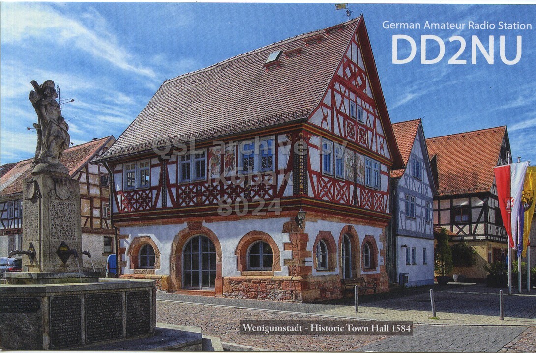 Front QSL card, of DD2NU to IK6BAK, February 26, 2023, CW mode. The QSL image contains the following objects: Monastery, City, Villa, Neighborhood, Street. And contains this text: German Amateur Radio Station DD2NU QSL archive ES 8024 Wenigumstadt-Historic Town Hall 1584.