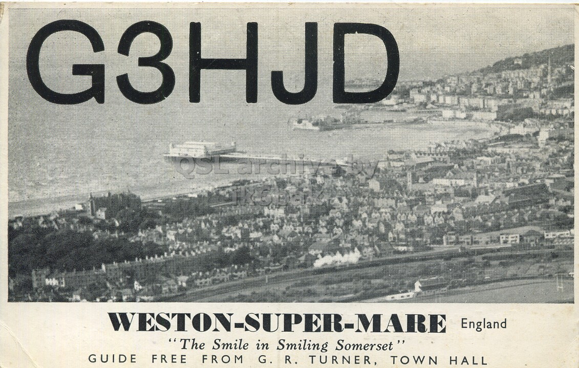 Front QSL card, of G3HJD to I1LCN, January 3, 1963, PH mode. The QSL image contains the following objects: Advertisement, Poster, Waterfront, Outdoors. And contains this text: G3HJD archiv WESTON-SUPER-MARE England "The Smile in Smiling Somerset " GUIDE FREE FROM G. R. TURNER, TOWN HALL G3HJD archiv WESTON-SUPER-MARE England "The Smile in Smiling GUIDE FREE FROM G. R. TURNER, TOWN HALL.