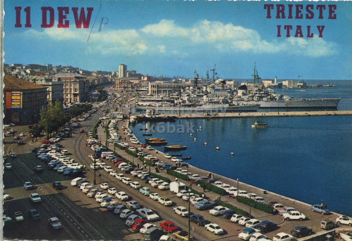 Front QSL card, of I1DEW/P to I1LCN/P, August 3, 1969, PH mode. The QSL image contains the following objects: Waterfront, Harbor, Pier, City, Port. And contains this text: TRIESTE ITALY 55 ik6bak TRIESTE ITALY 55 ik6bak.