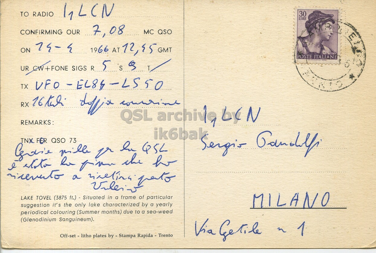 Right QSL card, of I1PEZ to I1LCN, April 14, 1966, PH mode. The QSL image contains the following objects: Envelope, Mail, Person, Postcard, Face. And contains this text: TO RADIO 30 LIRE CONFIRMING OUR 7,08 MC QSO ON 74-4 1966 AT 12,95 GMT POSTE ITALIANE UR CW+FONE SIGS R 5 S a T REMARKS: QSL archive 1 by N ik6bak TNX FER QSO 73 LAKE TOVEL (3875 ft.) - Situated in a frame of particular suggestion it's the only lake characterized by a yearly MILANO periodical colouring (Summer months) due to a sea-weed (Glenodinium Sanguineum). Off-set - litho plates by - Stampa Rapida - Trento Via Getile n TO RADIO 30 LIRE CONFIRMING OUR 7,08 MC QSO ON 74-4 1966 AT GMT POSTE ITALIANE UR CW+FONE SIGS R 5 S T TX UFO RX REMARKS: QSL archive 1 N ik6bak TNX FER QSO 73 Sergis GSL I v the a LAKE TOVEL (3875 ft.) - Situated in a frame of particular suggestion it's the only lake characterized by a yearly MILANO periodical colouring (Summer months) due to a sea-weed (Glenodinium Sanguineum). Off-set - litho plates Rapida - Trento Via Getile n.
