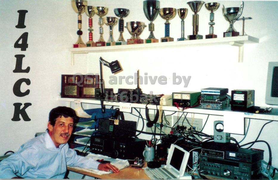 Front QSL card, of I4LCK to IK2GRA, December 15, 1995, CW mode. The QSL image contains the following objects: Table, Adult, Male, Man, Person. And contains this text: I4LCK QSL archive by I4LCK QSL archive by.