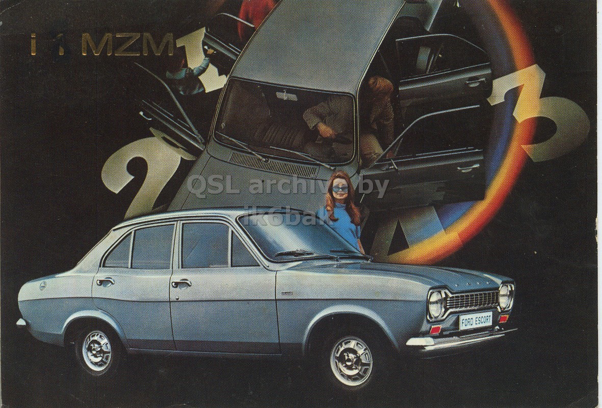 Front QSL card, of I8MZM to I2LCN, November 14, 1971, PH mode. The QSL image contains the following objects: Sedan, Alloy Wheel, Spoke, Wheel, License Plate. And contains this text: 3 2 QSL archiv by FORD ESCORT MZM 3 2 QSL archiv by FORD ESCORT.