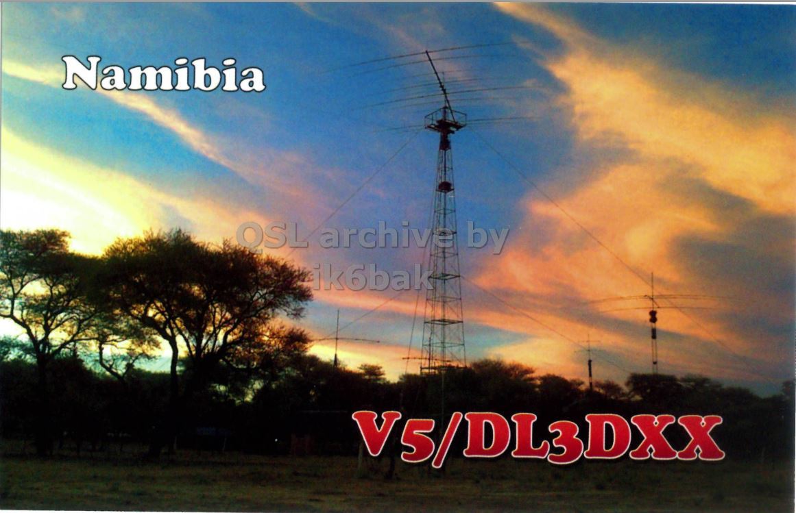 Front QSL card, of V5/DL3DXX to IK2GRA, December 21, 2014, CW mode. The QSL image contains the following objects: Tower, Electrical Device. And contains this text: Namibia ik6bak V5/DL3DXX.