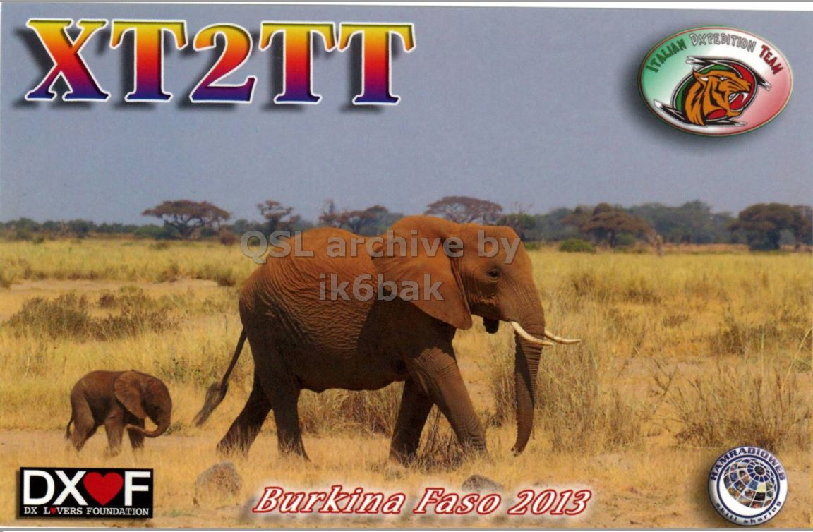 Front QSL card, of XT2TT to IK2GRA, February 27, 2013, CW mode. The QSL image contains the following objects: Animal, Elephant, Mammal, Wildlife, Grassland. And contains this text: XT2TT ITALIAN DXPEDITION TEAM QSL archive by ik6bak DX F Burkina Faso 2013 DX L VERS FOUNDATION XT2TT ITALIAN TEAM QSL archive by ik6bak DX F Burkina Faso 2013 DX L VERS FOUNDATION.